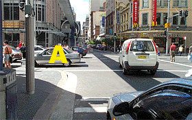 You wish to turn left at this intersection and the traffic lights are green.  What should you do?