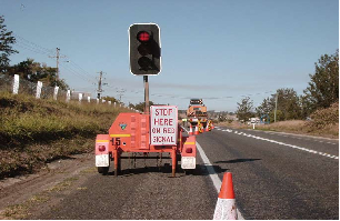 Where do you stop at temporary traffic lights?