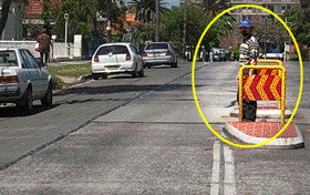 This person is standing on a pedestrian refuge.  If he steps out onto your lane you should -