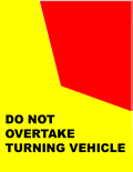 You are behind a long vehicle (7.5 m or more in length) that is signalling and starting to turn left. The truck is displaying a Do not overtake turning vehicle sign and is in the second lane from the left side of the road. You also want to turn left.  What must you do?