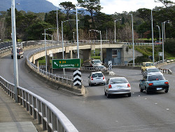 You are driving a vehicle along a multi-lane road and the speed limit is 80 km/h or less, which lane should you travel in?